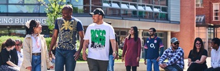 Students talking and walking across campus courtyard