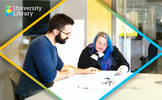 Student sitting beside librarian looking over some documents
