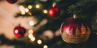 red baubles hanging on a Christmas tree