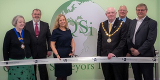 Group of representatives cut the ribbon for an official room opening