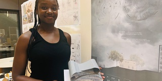 Architecture student standing next to her design work at Architecture Show