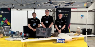 Three Aerospace students displaying work at RAF Cosford