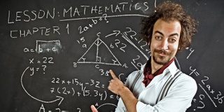 An image of a man teaching maths in front of a blackboard