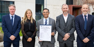 Group of partners including the Vice Chancellor with a signed copy of the agreement