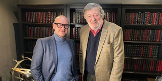 Professor standing with actor and comedian Stephen Fry