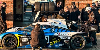 Motorsport racing team UWR working trackside on a Praga car