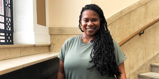 Photograph of a black female student at the top of the Wulfruna Building staircase