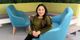 Honorary Graduate Shani Dhanda seated looking at the camera