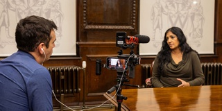 Research academic Opinderjit Takhar being filmed by BBC Midlands Today