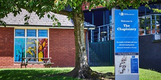 Outside the University Chaplaincy building, tree in foreground
