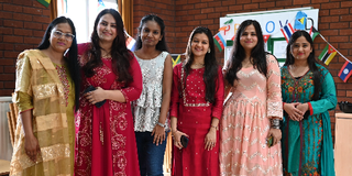 A group of female Indian students wearing traditional Indian dress in the Chaplaincy for the Dussehra celebration