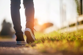 bottom of legs walking into a sunset