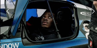 A University of Wolverhampton Race team student looking out of the window of the Praga racing car