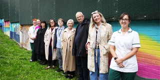 line up of staff and artists involved in the Arts for Health garden mural project at St Georges Hospital Staffordshire