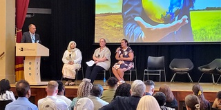 Strategic Leadership and Management training course celebration event - panel discussion on stage at the Chancellor's Hall