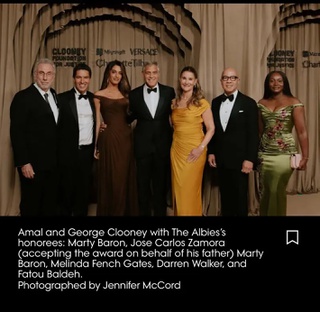 Fatou Baldeh posting with George Clooney and guests at the Clooney Foundation Awards