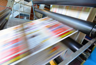 A blurred image of something being printed on a press