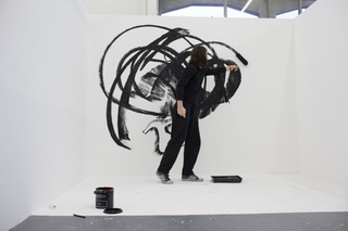 A person painting on a big canvas
