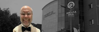 Headshot of David Matheson in front of a monochrome backdrop of the Ambika Paul building