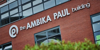 Ambika Paul Building close up on exterior signage in courtyard