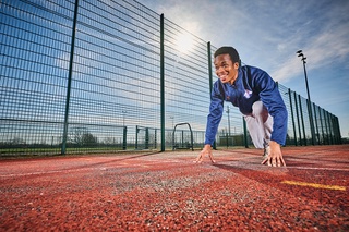 Image of a student preparing to run on the track at Walsall Campus.
