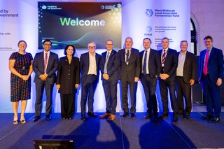 Picture by Thom Bartley and shows 10 men and women dressed in smart clothing lining up. They are representatives from West Midlands Universities.