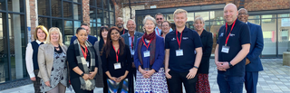 Group photograph of members of staff at Springfield campus, pictured wearing matching lanyards.