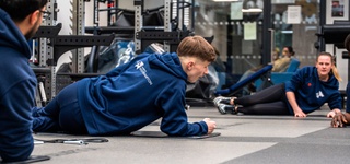 Three students using sports facilities