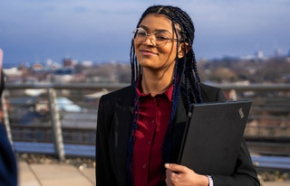 A health and social care student standing with nice background of blue sky facing away from camera