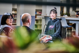 student smiling in library
