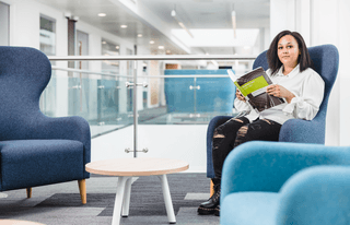 a student reads on the atrium
