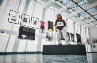 a student standing in a gallery