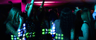 A club in Walsall with small coloured lights shining onto a crowd of dancing patrons in the dark