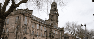 A historical building in Walsall, with an arching doorway and a tall tower