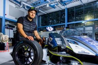 A student handing a Motorsport car