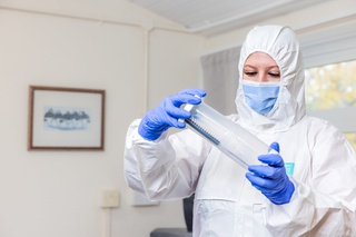 A scientist handling a tube