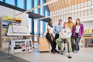 Group of Architecture students sitting in their workshop space, well lit and modern interior of the buidling.