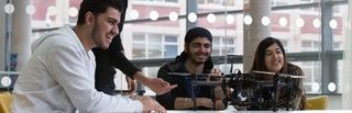Students working on a drone in a classroom