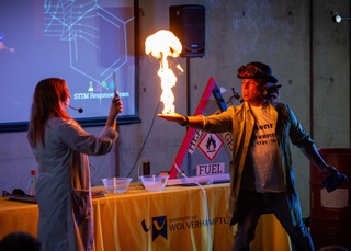 Image of Heather and Dr K creating fire on hands.