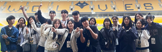 students standing together and posing for a photo standing on the pitch at Wolverhampton Football Club Stadium