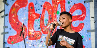 Boy singing with microphone in his hand