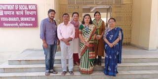 Group of students with researcher outside University in India