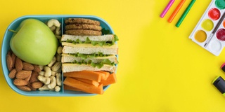 A colourful picture of a packed lunch on a school table
