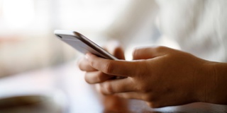 Hands holding a mobile phone