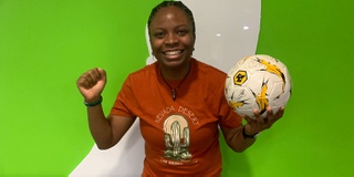 Student's Union President holding a Wolves signed football ready for auction