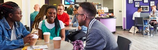 image of a group of students sitting together laughing chatting