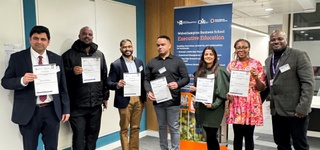Photograph of academics from the first cohort of the WMCA Strategic Leadership Course holding certificates