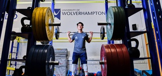 Student lifting weights